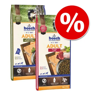 Două saci de hrană uscată pentru câini bosch Adult, vizibile variantele cu pui și mei, respectiv miel și orez, 21,5% proteine, 10,5% grăsimi, ambalaj 15 kg, simbol procent reducere.