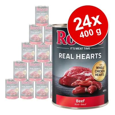 Rocco Real Hearts Beef, 24 konzerv po 400 g. Na embalaži piše: 'with whole chicken hearts'. Vidna slika mesa in src na pločevinki.