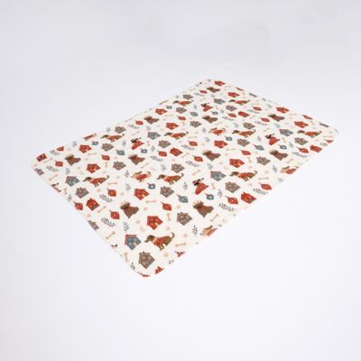 Coperta rettangolare con motivo colorato di cucce, ossa e cani su sfondo color crema.