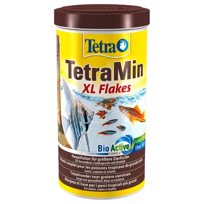 Tetra TetraMin XL Flakes fish food tub, BioActive Formula, visible text in multiple languages for ornamental fish, yellow label with images of tropical fish and flakes