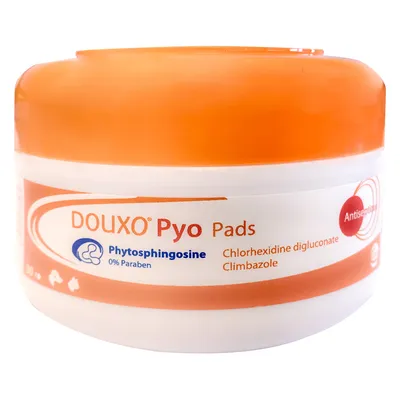 DOUXO Pyo Pads, Phytosphingosine 0% Paraben, Chlorhexidine digluconate, Climbazole zichtbaar op verpakking. Antiseptisch product in oranje-witte pot.