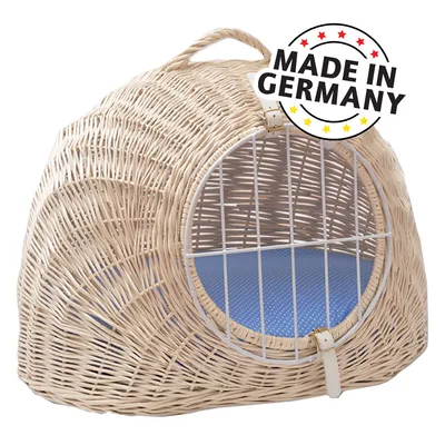 Carrier basket made of light rattan with metal grid and blue inner cushion. Text: Made in Germany.