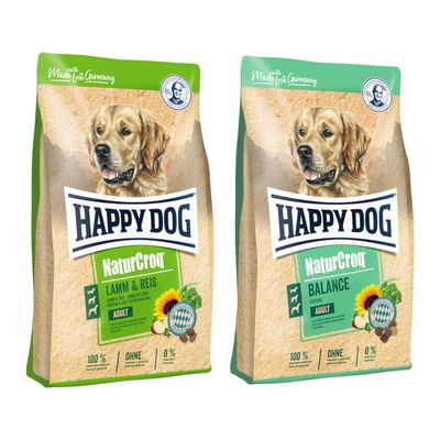 To poser Happy Dog NaturCroq hundefoder: Rind & Reis og Lamm & Reis. Stor gul procenttegn indikerer tilbud eller rabat.