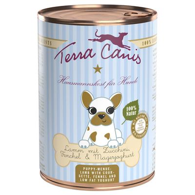 Lata de comida para perros Terra Canis. Texto visible: 'Hausmannskost für Hunde', '100% Natur', 'Lamm mit Zucchini, Fenchel & Magerjoghurt', 'Puppy-Menue: Lamb with courgette, fennel and low fat yoghurt'.