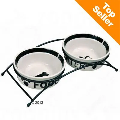 Kaksi keraamista kuppia mustalla metallitelineellä, toisessa teksti FOOD ja luun kuva, toisessa teksti WATER. Yläkulmassa oranssi merkki: Top Seller. Kaksi keraamista kuppia mustalla metallitelineellä, toisessa teksti FOOD ja luun kuva, toisessa teksti WATER. Yläkulmassa oranssi merkki: Top Seller.