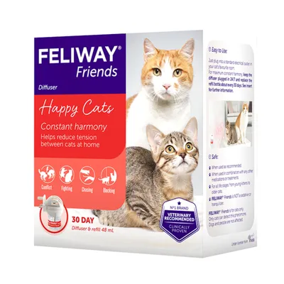Feliway Friends diffuser packaging showing product benefits: helps reduce tension between cats at home, icons for conflict, fighting, chasing, blocking, and instructions for use and safety.