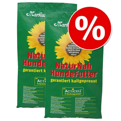 Two green bags labelled NaturNah HundeFutter garantiert kaltgepresst with a sunflower image and a red percentage discount symbol, indicating a special offer on this product. Two green bags labelled NaturNah HundeFutter garantiert kaltgepresst with a sunflower image and a red percentage discount symbol, indicating a special offer on this product.