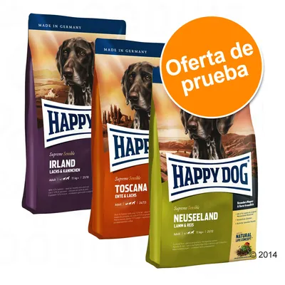 Tres sacos de pienso Happy Dog Supreme Sensible: Irland (salmón y conejo), Toscana (pato y salmón), Neuseeland (cordero y arroz). Círculo naranja con texto: Oferta de prueba.