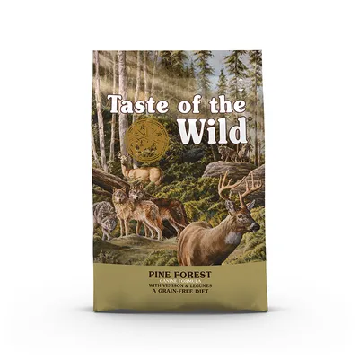 Упаковка Taste of the Wild Pine Forest. Видны надписи: Canine Formula with Venison & Legumes, A Grain-Free Diet. Иллюстрация леса с оленями и волками.