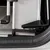Close-up of a metal and plastic locking mechanism on a pet transport crate, showing secure attachment to the vehicle interior.