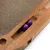 Cat toy made of wood with scratching surface and two purple balls in an integrated compartment.