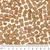 Close-up of brown, square dry food pieces with a centimetre scale at the bottom edge of the image.