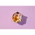 Bowl containing raw chicken pieces, a chicken drumstick, sliced carrots, sweet potato, parsnip, half a boiled egg and a dark dried piece, displayed on a purple background.