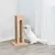 Scratching furniture made of wood with sisal surfaces, white cat playing with attached toy.