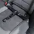 Black safety belt with carabiner hook, attached to a car seat with ISOFIX system.