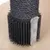 Scratching post with black sisal rope, brush attachment and grey plush material.