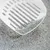 White litter scoop with grey cat litter and blue particles, suitable for cleaning cat toilets.