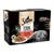Embalagem Sheba Fine Flakes in Jelly Succulent Selection, 12x85g, com vaca, frango, cordeiro e peru. Prato de comida para gato e imagem de gato cinzento visíveis.