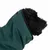 Black dog wearing green towel with black border, suitable for drying or grooming.