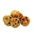 Round snacks with visible ingredients such as grains, fruits and seeds. Colourful mix of yellow, red and black.