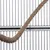 Close-up of a brown rope in front of a black metal grid, suitable for cage accessories or decoration.