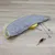 Toy set with grey cover, yellow base and accessories such as rods and feather attachments. Suitable for interactive play.