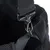Close-up of a silver carabiner attached to a grey fabric strap with mesh material in the background.