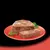 Sliced portion of wet pet food loaf served on a red plate with herbs, showing texture and consistency of the product.