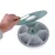 Round feeding station with six numbered compartments and removable lid, brand Trixi. Hand shows lid opening.