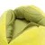 Close-up of yellow-green, padded fabric material with soft surface and stitching. Interior details visible.