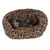Dog lying relaxed in an oval pet bed with leopard pattern and soft padding. Visible logo: TIA.
