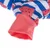 Detailaufnahme eines Kleidungsstücks mit Wassermelonenmuster und rot-weiss-blauen Streifen, Ärmelabschluss in Korallenrot.