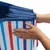 Foldable box with blue edge and colourful stripes, being folded by hands.