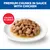 Premium Chunks in Sauce with Chicken. Chunks in Gravy visible on a white plate. Premium Chunks in Sauce with Chicken. Chunks in Gravy visible on a white plate.