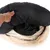 Hand lifting the black cover of a round, plush pet bed to show removable or washable inner padding.