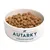 Bowl filled with Autarky complete dog food kibble, showing product name and type on the bowl.