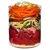 Glass container with visible layers of raw beef chunks, millet, courgette strips, apple slices, grated carrot and chopped celery. All ingredients clearly separated in the jar.