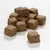 Morceaux cubiques de friandises brunes pour animaux, texture compacte et granuleuse, sans emballage ni marque visible, posés sur une surface blanche.