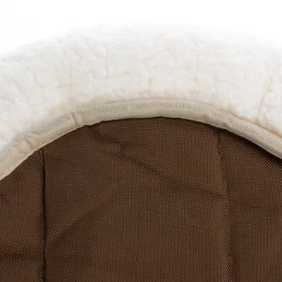 Close-up of brown fabric material with a white, soft plush edge. Detailed view of textures and seams.