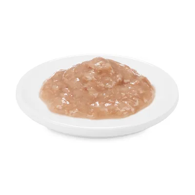 Close-up of wet food on a white plate, showing the product’s texture and colour.
