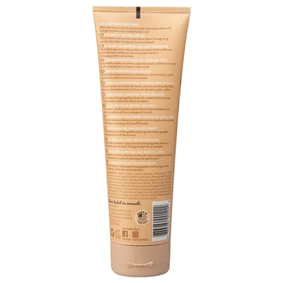 Retro di una bottiglia con descrizione del prodotto: Delicate Skin Conditioner, avena e olio di marula, per pelle sensibile. Made in USA, senza test sugli animali. Link ai social media visibili.