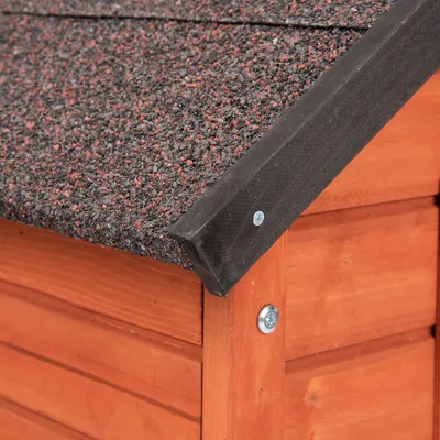 Detailweergave van een houten dierenhuis met weerbestendig bitumen dak en stevige schroefverbinding.