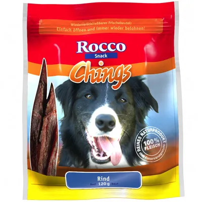 Rocco Snack Chings, Rind 120 g. Texte visible : 100 % Fleisch, Reines Naturprodukt, ohne Konservierungsstoffe. Sachet avec morceaux de viande et photo d’un chien.