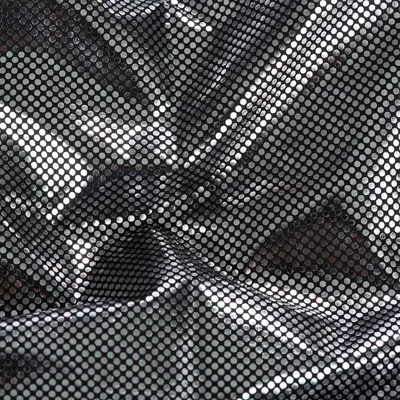 Close-up of black fabric with a silver dotted mesh pattern, showing texture and material detail for product identification.
