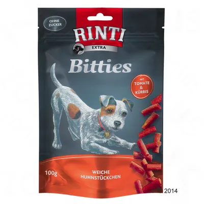 Sachet Rinti Extra Bitties 100g, morceaux tendres de poulet, mention 'ohne zucker', 'mit tomate & kürbis', texte allemand 'weiche huhnstückchen' visible sur l'emballage.