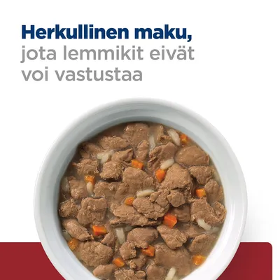 Teksti: Herkullinen maku, jota lemmikit eivät voi vastustaa. Kuvassa kulhollinen kastikkeessa olevia lihapaloja ja vihanneksia.