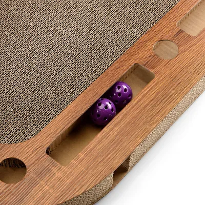 Cat toy made of wood with scratching surface and two purple balls in an integrated compartment.