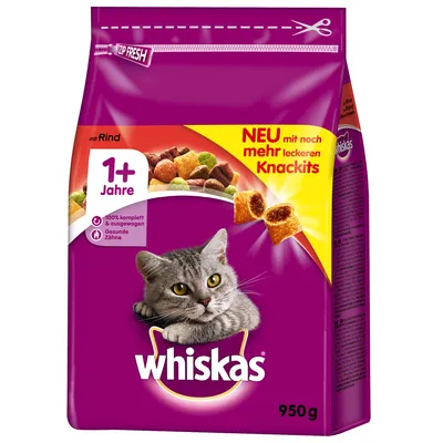 Whiskas dry cat food, 950g pack, visible text: 1+ Jahre, mit Rind, NEU mit noch mehr leckeren Knackits. Purple packaging with image of grey cat and kibble pieces.