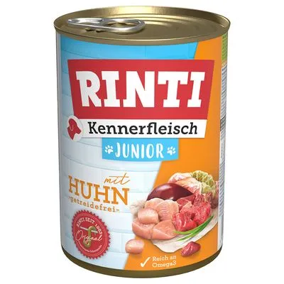 RINTI Kennerfleisch Junior met Huhn, graanvrij. Afbeelding van stukjes kip, vlees en groente op het blik. Tekst: 'Reich an Omega3', 'Jetzt seit 2003 Original'.