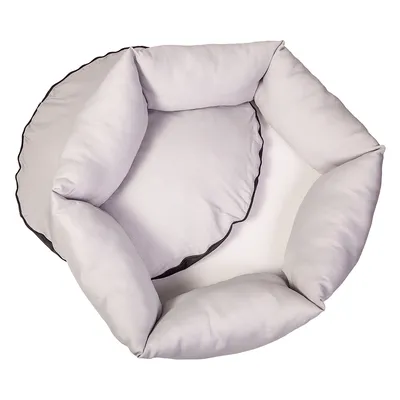 Panier pour animaux gris, rond, avec côtés rembourrés et surface de couchage douce.